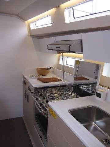 Slide: The Image of Modern kitchen in 2024 Jeanneau 55 yacht with stainless steel appliances and ample counter space. - 28
