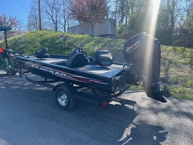 Slide: The Image of 2024 Tracker Pro Team 190 TX boat with Mercury engine on a trailer, outdoors. - 3