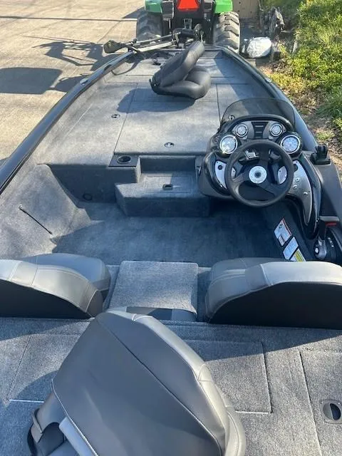 Slide: The Image of 2024 Tracker Pro Team 190 TX boat interior with steering console and seating. - 6