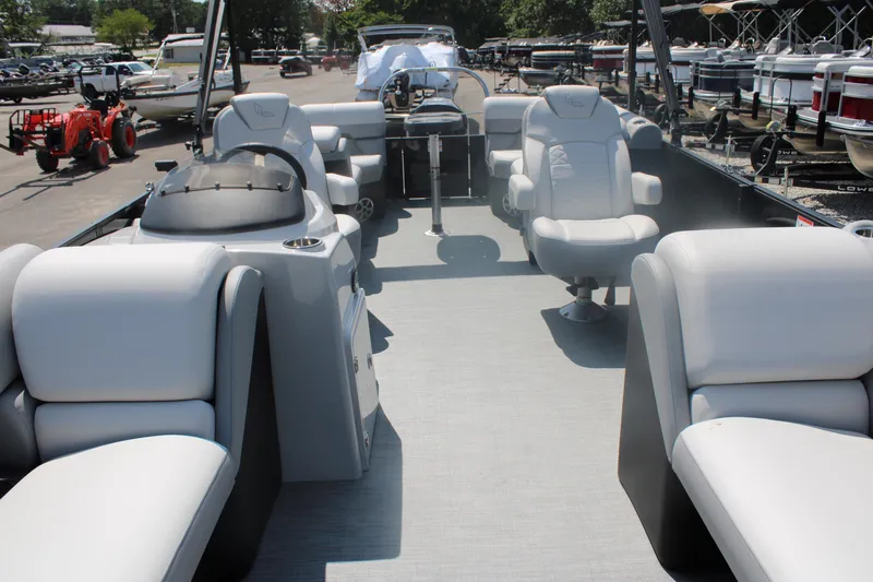 Slide: The Image of 2023 Lowe SS230 Super Sport pontoon boat interior with white seating and helm. - 4