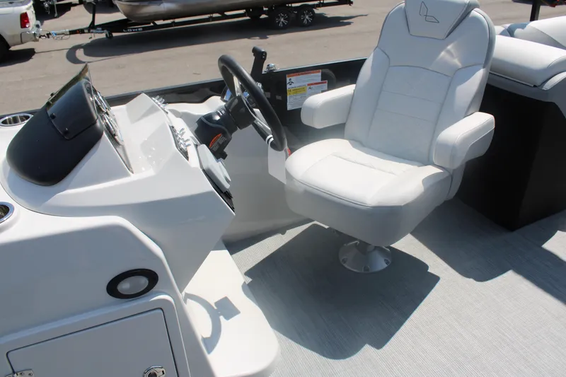 Slide: The Image of 2023 Lowe SS230 Super Sport boat interior with captain's chair and steering console. - 5
