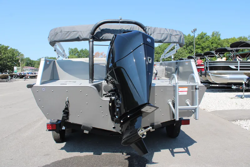 Slide: The Image of 2023 Lowe SD224 Sport Deck boat rear view with outboard motor and ladder. - 3