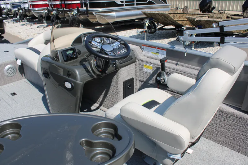 Slide: The Image of 2023 Lowe SD224 Sport Deck boat interior with steering console and seating. - 7