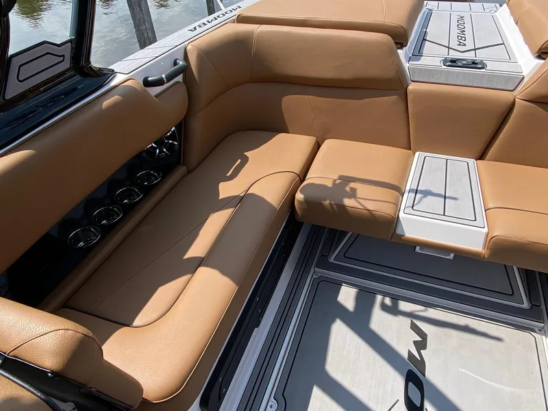 Slide: The Image of 2023 Moomba Craz boat interior with tan leather seating and cup holders. - 10