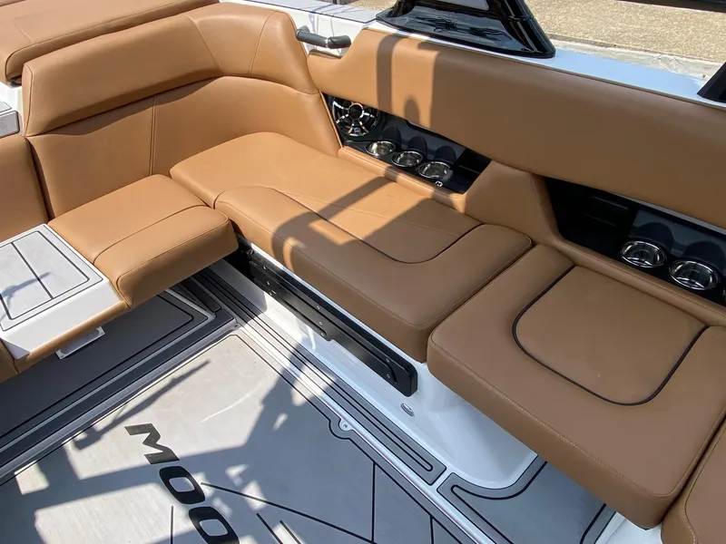 Slide: The Image of 2023 Moomba Craz boat interior with tan leather seating and cup holders. - 12