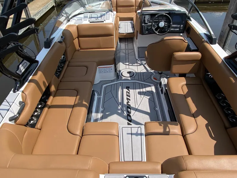 Slide: The Image of 2023 Moomba Craz boat interior with tan seating and modern dashboard. - 16