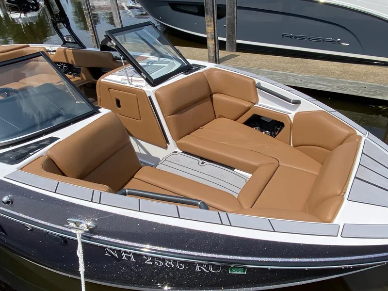 Slide: The Image of 2023 Moomba Craz boat with tan leather seats docked at marina. - 17