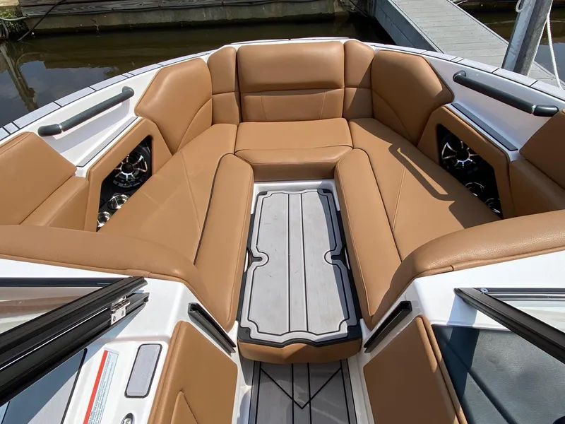 Slide: The Image of 2023 Moomba Craz boat interior with tan leather seating and gray flooring. - 19