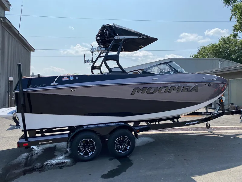 Slide: The Image of 2023 Moomba Craz boat on trailer, black and white exterior, parked outdoors. - 4