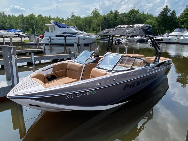 Slide: The Image of 2023 Moomba Craz boat docked at a marina with other boats in the background. - 5