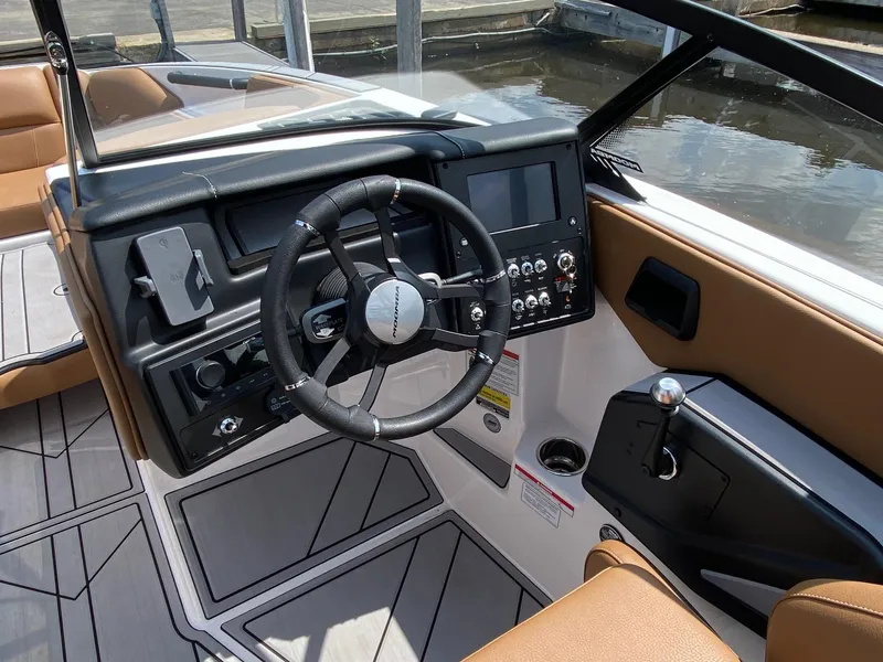 Slide: The Image of 2023 Moomba Craz boat dashboard with steering wheel and control panel. - 8