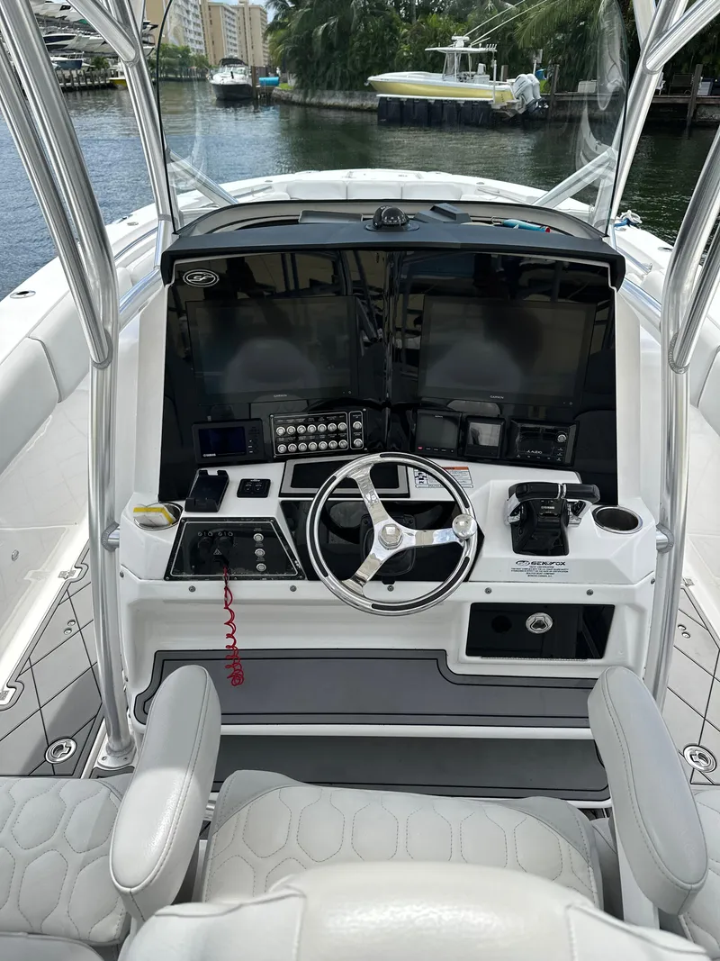 Slide: The Image of 2020 Sea Fox 328 Commander boat helm with dual screens and steering wheel. - 4