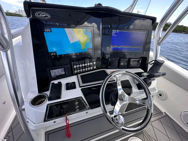 Slide: The Image of 2020 Sea Fox 328 Commander helm with dual displays and steering wheel on open water. - 6