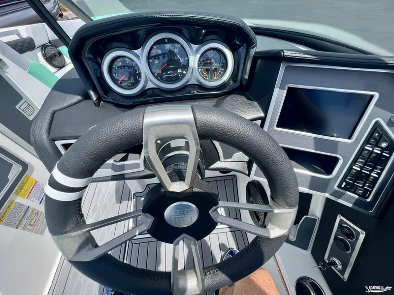 Slide: The Image of 2023 MasterCraft XT24 boat dashboard with steering wheel and gauges. - 5