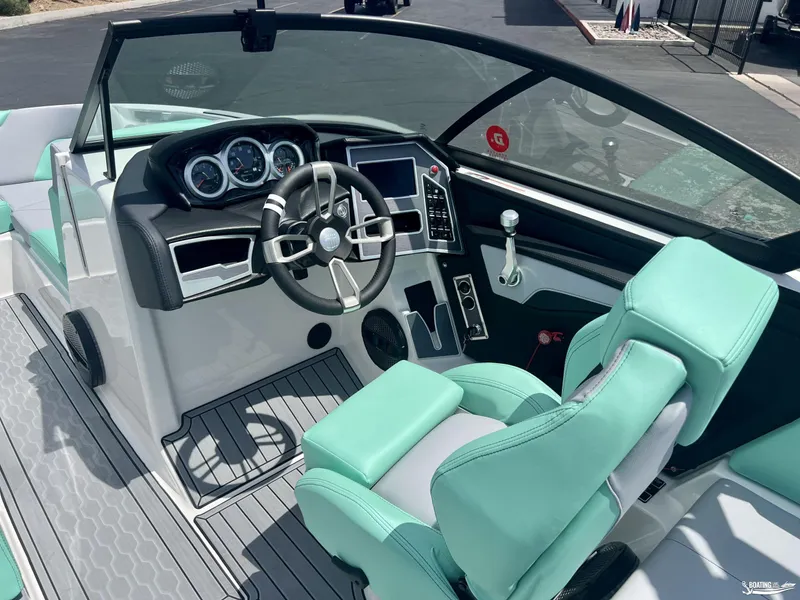 Slide: The Image of 2023 MasterCraft XT24 boat interior with modern dashboard and mint green seating. - 7