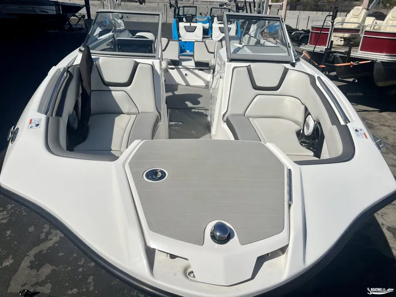 Slide: The Image of 2021 Yamaha Boats AR250 interior with spacious seating and modern design. - 7