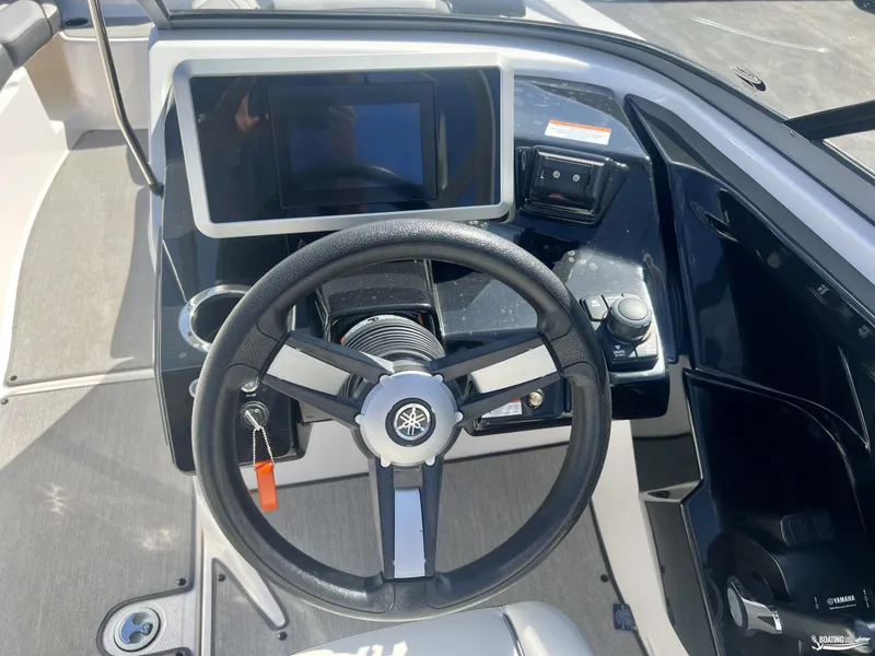 Slide: The Image of 2021 Yamaha AR250 boat dashboard with steering wheel and control panel. - 8