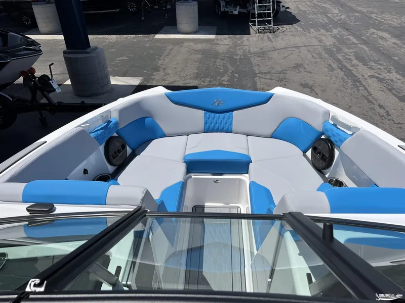 Slide: The Image of 2023 MasterCraft XT22 boat interior with blue and white seating. - 5