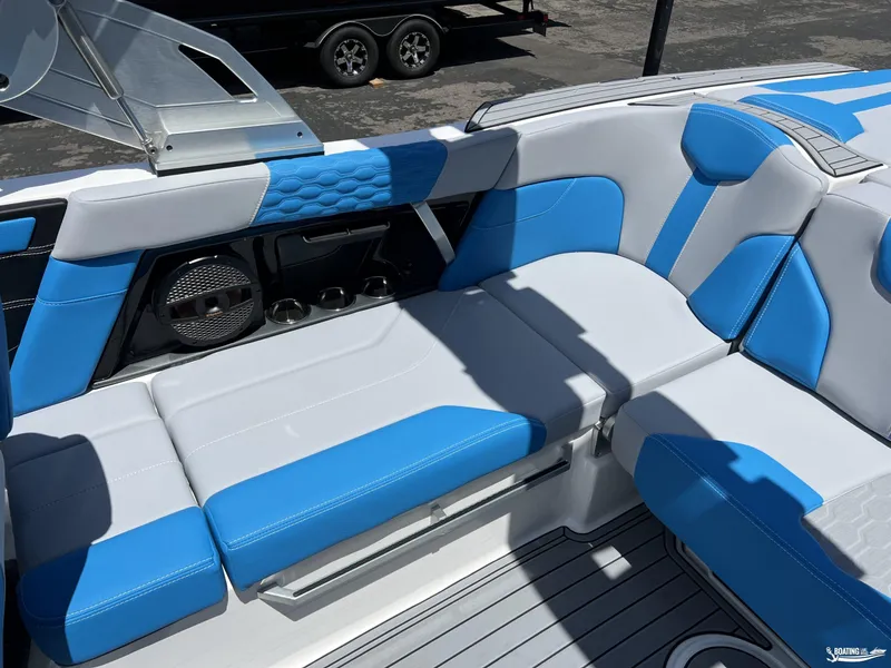 Slide: The Image of 2023 MasterCraft XT22 boat interior with blue and white seating. - 6