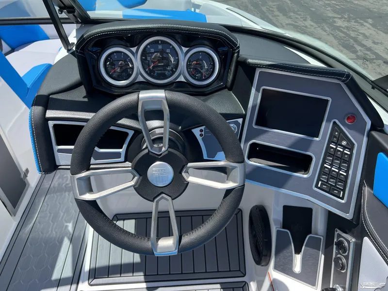 Slide: The Image of 2023 MasterCraft XT22 boat dashboard with steering wheel and control panel. - 9