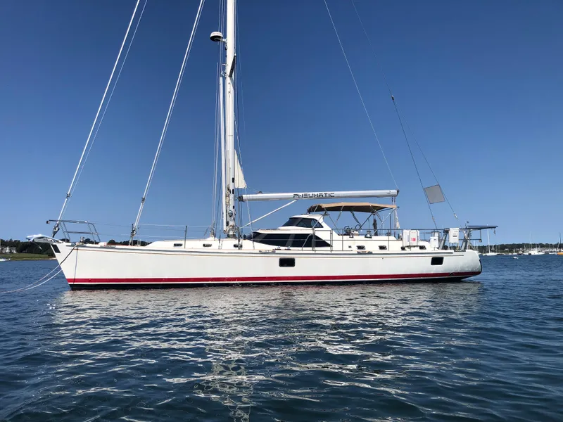 The Image of Sailing yacht Outbound 56, 2020 model, anchored on calm water under clear blue sky. - 0