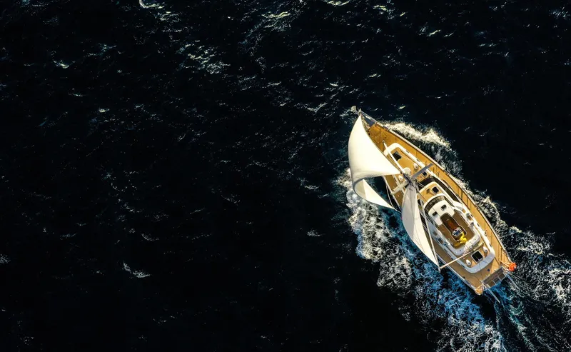 Slide: The Image of Aerial view of 2020 Outbound 56 sailboat navigating dark ocean waters. - 12
