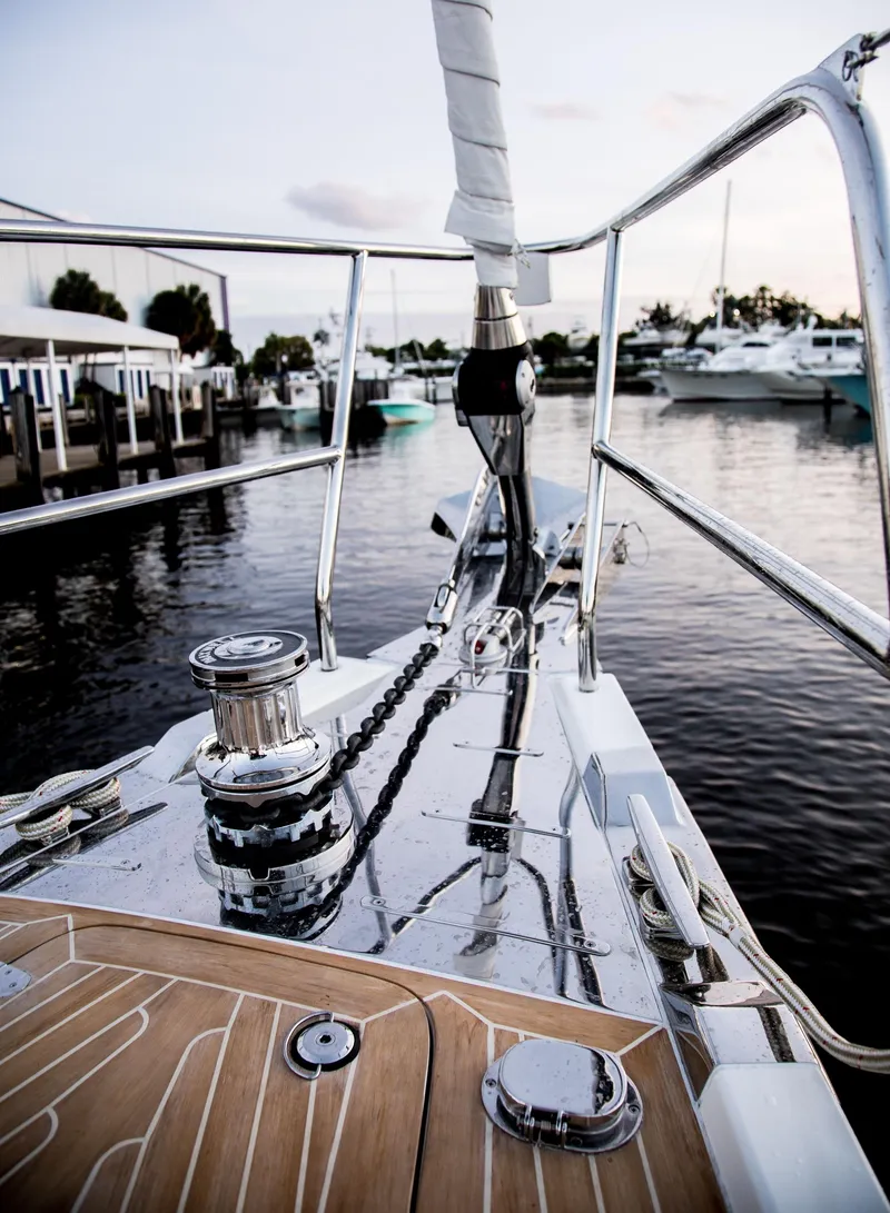 Slide: The Image of Outbound 56 sailboat bow, 2020 model, docked at marina with polished deck and winch. - 13