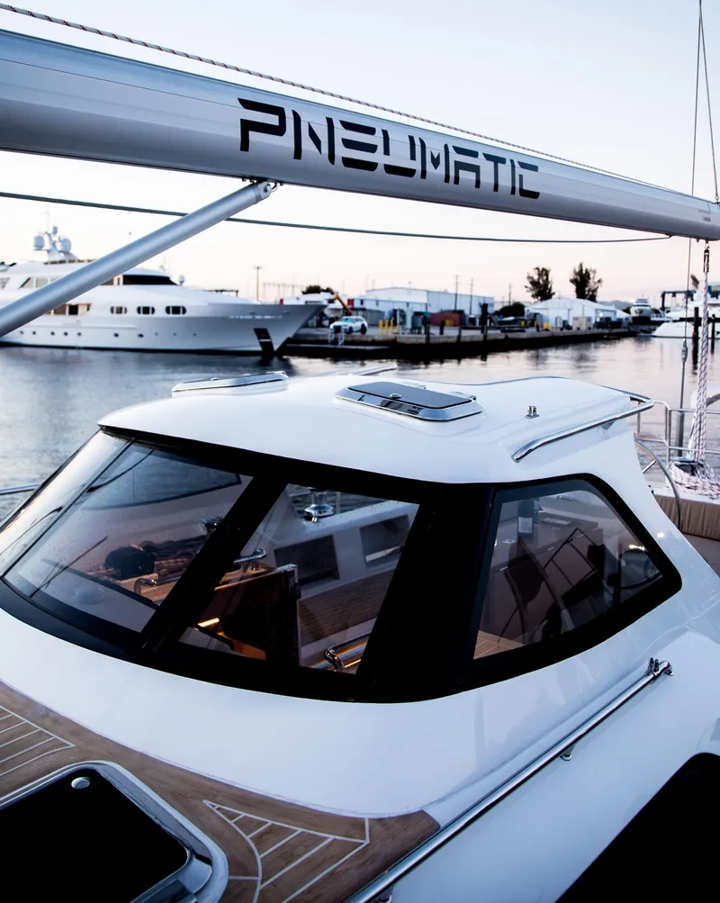 Slide: The Image of Sleek 2020 Outbound 56 yacht docked at marina during sunset. - 14