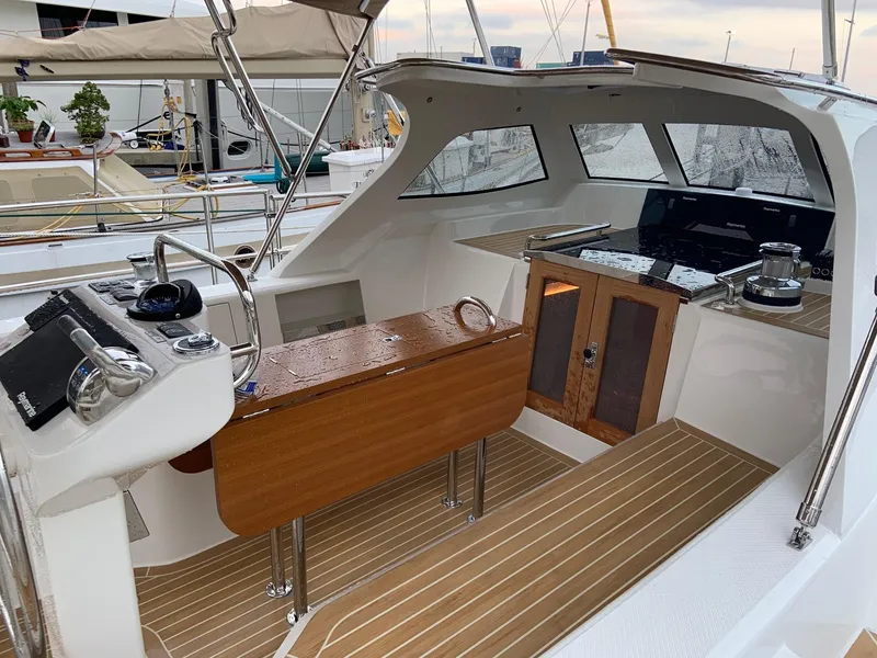 Slide: The Image of Modern Outbound 56 yacht cockpit with wooden table and navigation equipment, 2020 model. - 15