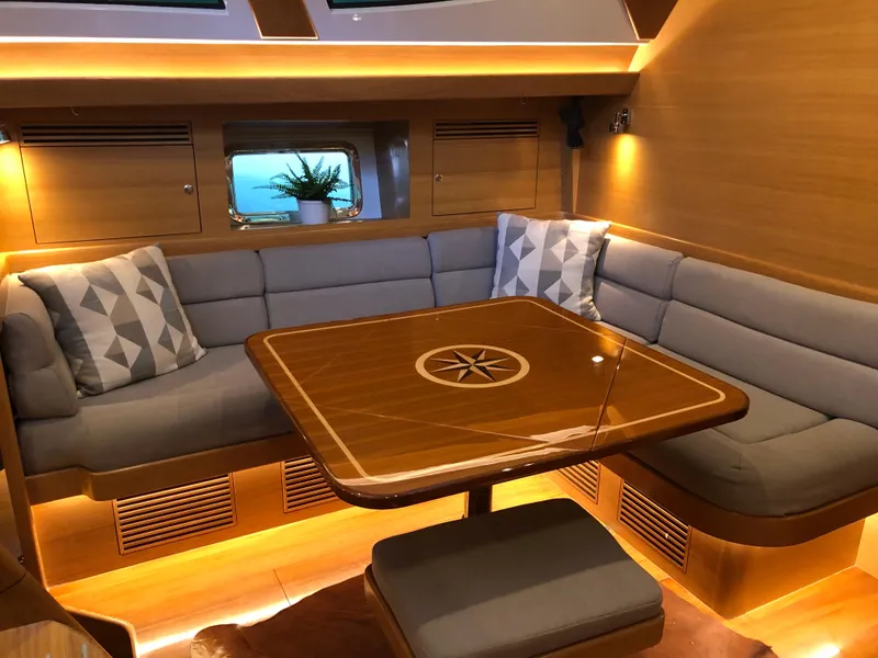Slide: The Image of Luxurious interior of 2020 Outbound 56 yacht with cozy seating and elegant wooden table. - 16