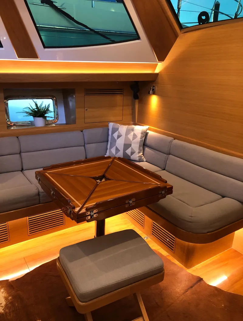 Slide: The Image of Luxurious interior of 2020 Outbound 56 yacht with cozy seating and elegant wooden table. - 20