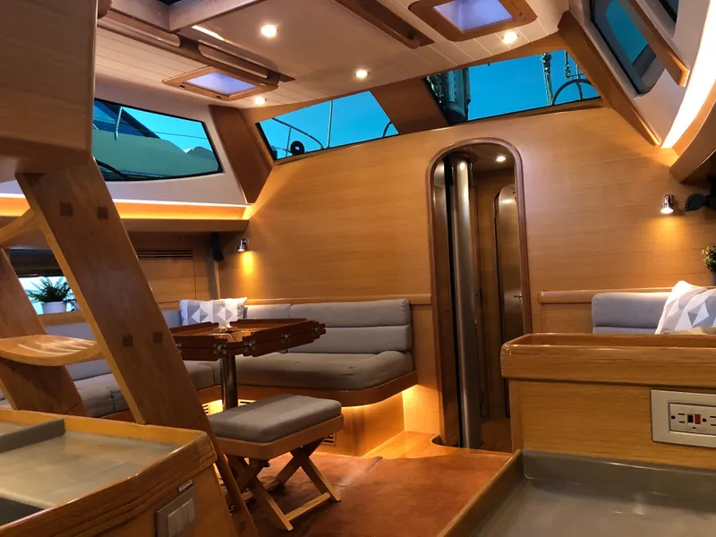 Slide: The Image of Luxurious interior of 2020 Outbound 56 yacht with modern wood finishes and ambient lighting. - 22