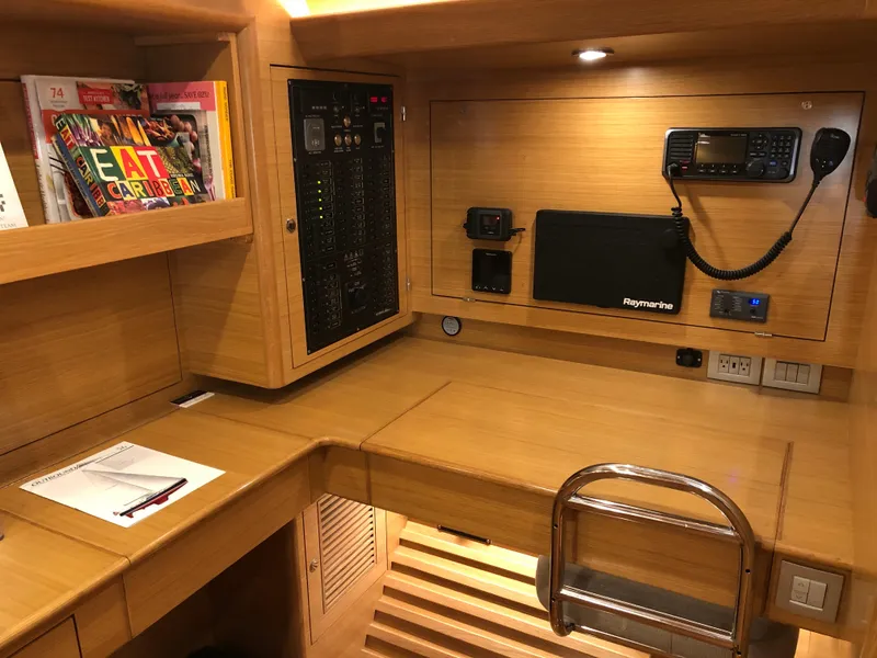 Slide: The Image of ```json
{
  "alt_text": "Outbound 56 yacht interior with navigation equipment and books, 2020 model."
}
``` - 25
