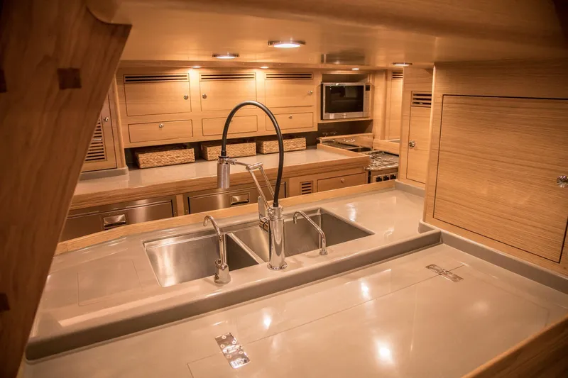 Slide: The Image of Luxurious kitchen interior of 2020 Outbound 56 yacht with modern fixtures and wooden cabinetry. - 28