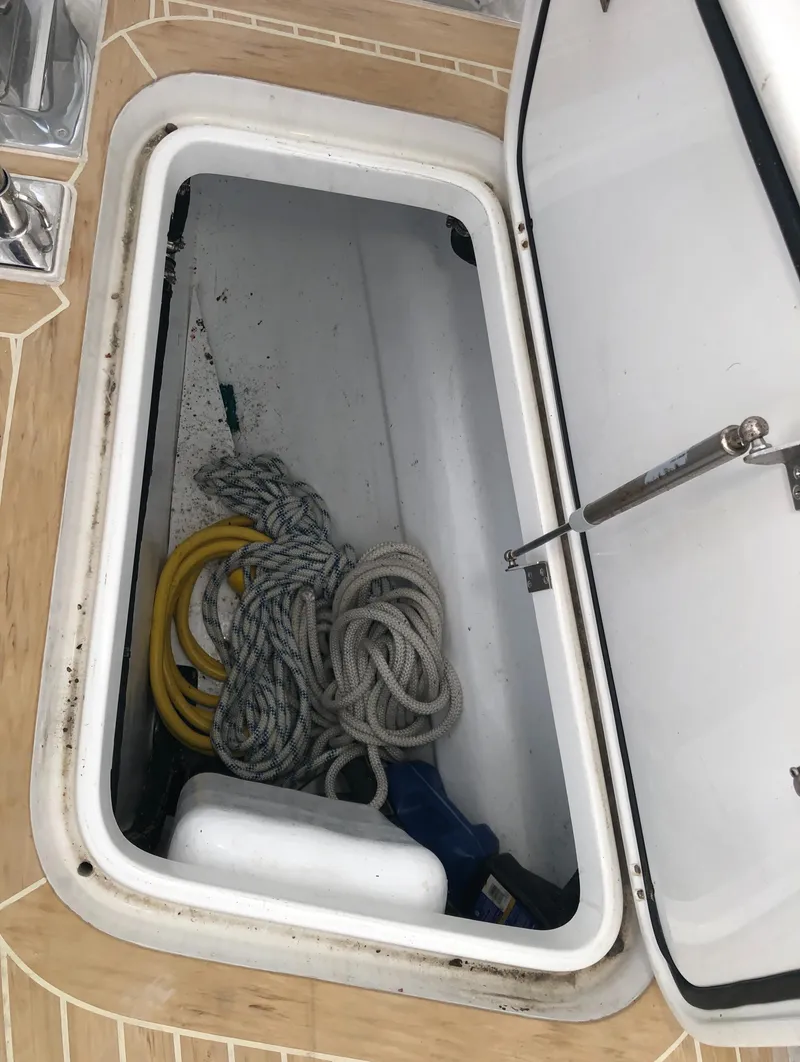 Slide: The Image of Open storage compartment on 2020 Outbound 56 boat with ropes and equipment. - 34