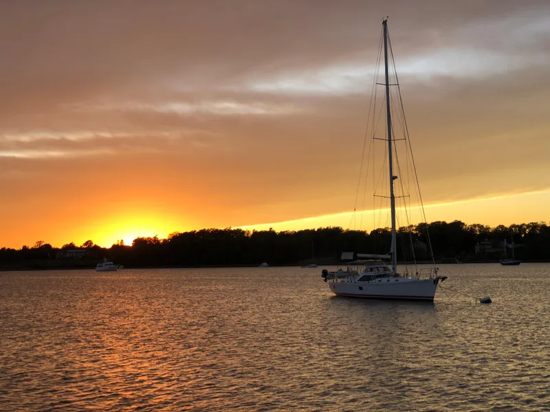 Slide: The Image of Sailboat on calm water at sunset, Outbound 56, 2020 model. - 43