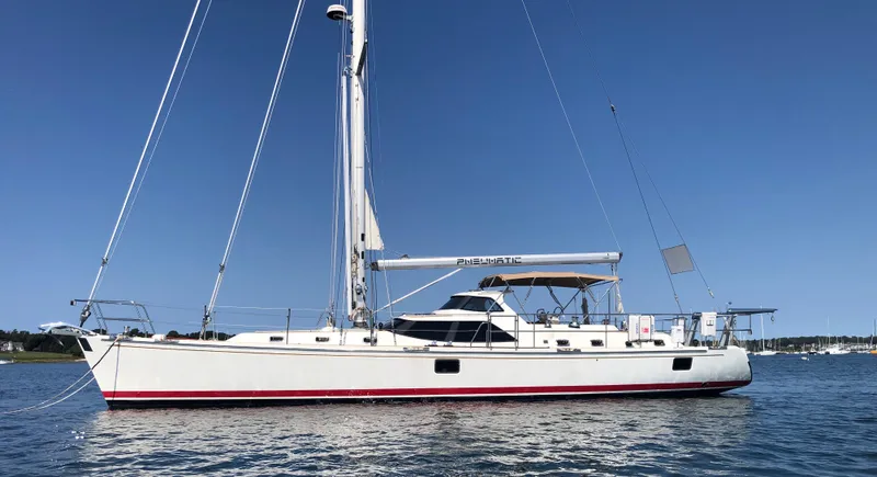 Slide: The Image of Sailing yacht Outbound 56, 2020 model, on calm waters under clear blue sky. - 47