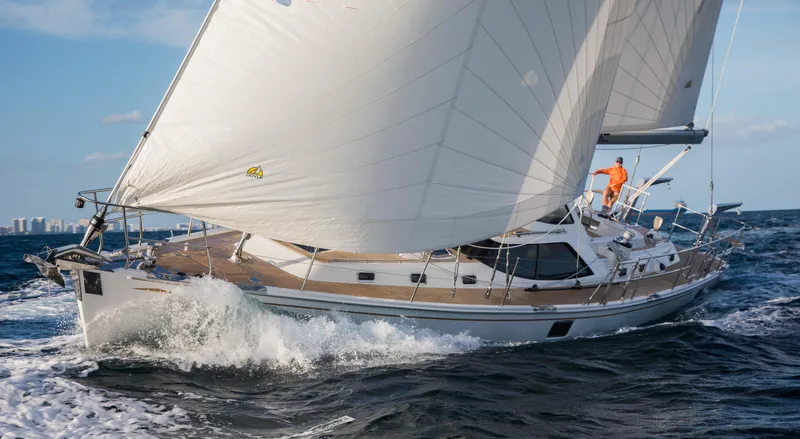 Slide: The Image of Sailing yacht Outbound 56, 2020 model, navigating ocean waves under full sail. - 5
