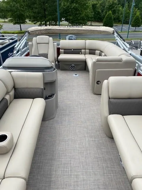 Slide: The Image of 2024 Sun Tracker Party Barge 20 DLX interior with beige seating and spacious layout. - 10