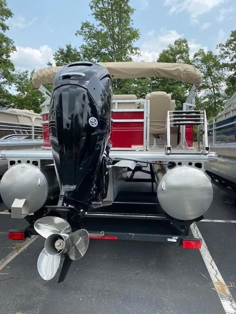 Slide: The Image of 2024 Sun Tracker Party Barge 20 DLX pontoon boat, rear view with outboard motor. - 11