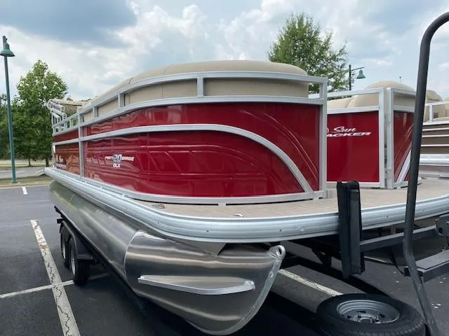 Slide: The Image of 2024 Sun Tracker Party Barge 20 DLX pontoon boat in red on a trailer. - 7