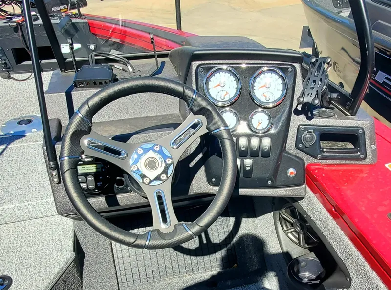 Slide: The Image of 2024 Tracker Targa V-19 WT boat dashboard with steering wheel and instrument panel. - 4