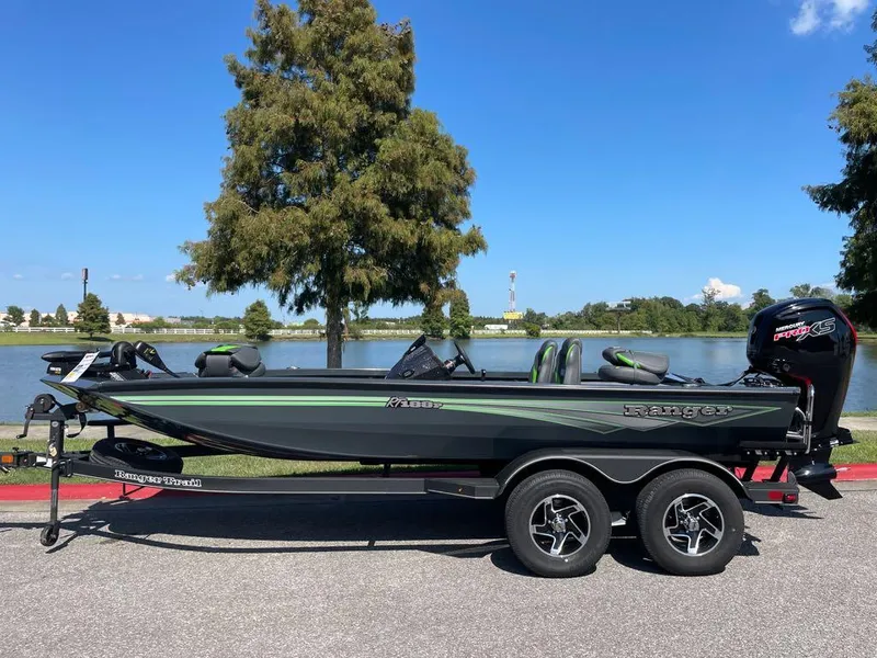 Slide: The Image of 2024 Ranger RT188P fishing boat on trailer by a lake. - 1