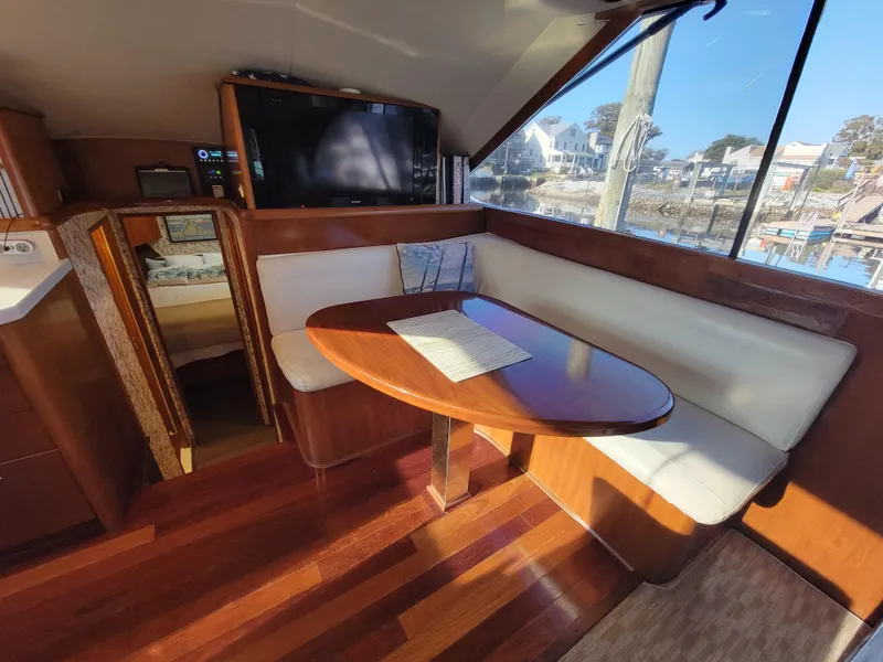Slide: The Image of Interior of 1991 Ocean Yachts 42 Super Sport with dining area and large window. - 12