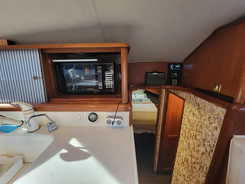 Slide: The Image of 1991 Ocean Yachts 42 Super Sport kitchen area with microwave and sink. - 14