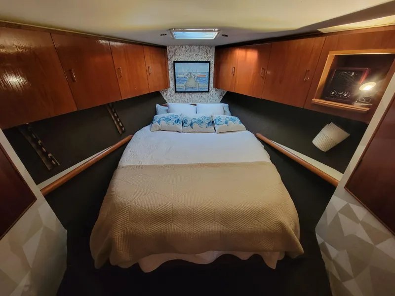 Slide: The Image of 1991 Ocean Yachts 42 Super Sport bedroom with double bed and wooden cabinets. - 16