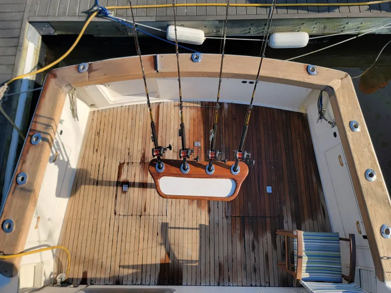 Slide: The Image of 1991 Ocean Yachts 42 Super Sport fishing deck with rod holders and wooden flooring. - 23