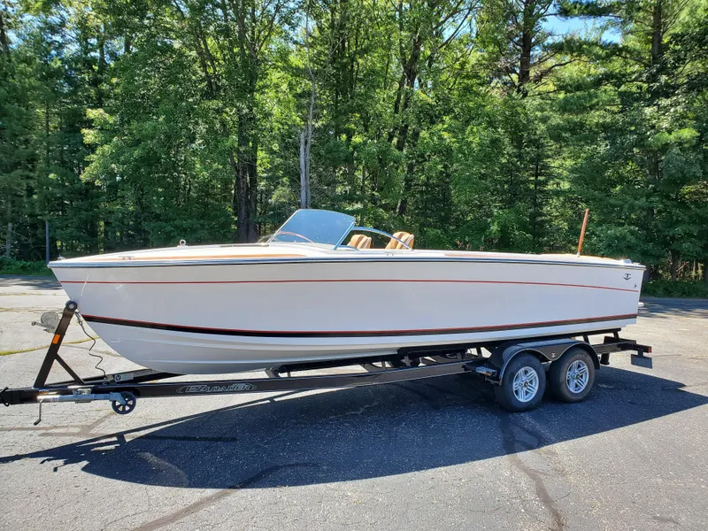 Slide: The Image of 2023 Thoroughbred u23i boat on a trailer in a wooded area. - 0