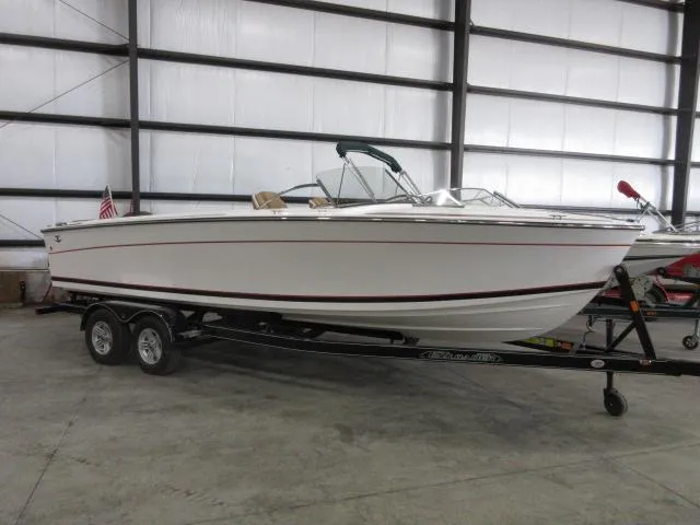 Slide: The Image of 2023 Thoroughbred u23i boat on a trailer in a warehouse. - 1