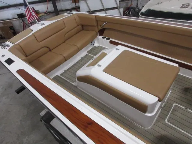 Slide: The Image of 2023 Thoroughbred u23i boat interior with tan leather seats and wooden accents. - 10